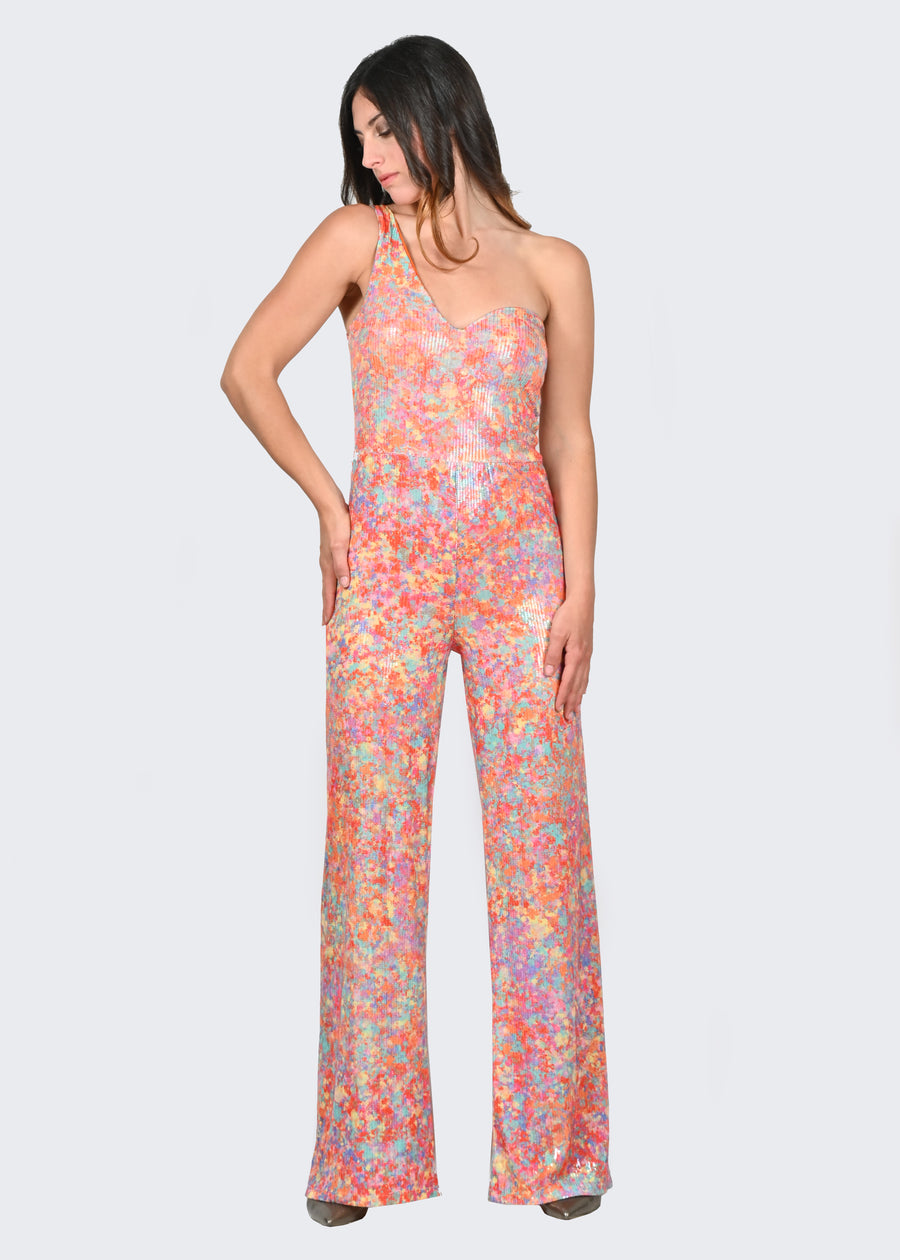 La tuta intera monospalla Lady è in paillettes con fantasia "Cristalli", proveniente da uno dei Dipinti Millyblu. Il modello è a vita alta con pantalone dalla linea scivolata e scollatura a cuore. La tuta intera elegante ha le coppe fisse ed è foderata.