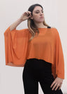 Poncho in tulle arancio con effetto vedo non vedo. La stola in tulle è un must have. È possibile indossarla anche come foulard per valorizzare l'outfit. Taglia unica.