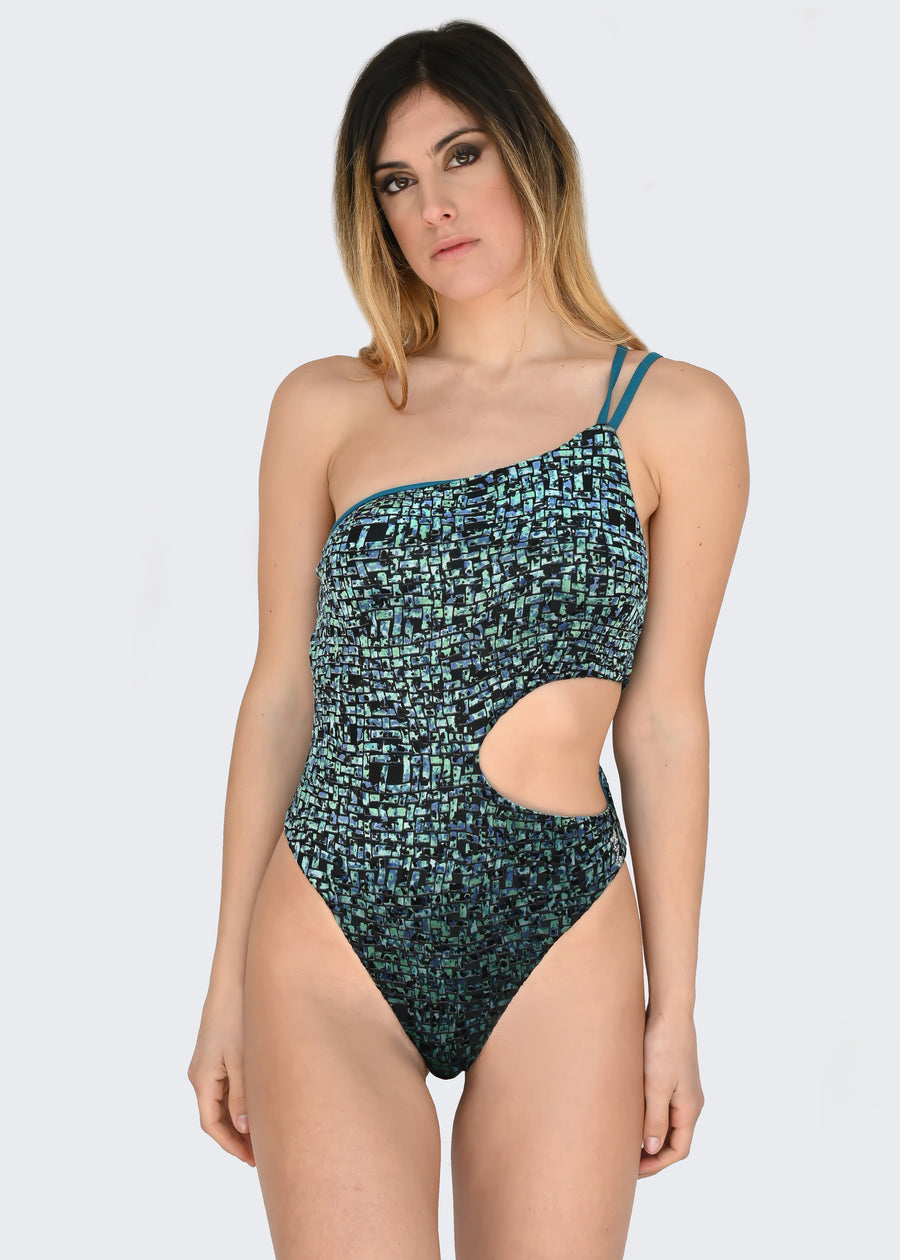 Costume monospalla in microfibra ottanio e velluto verde. Il costume intero sgambato ha le coppe estraibili e doppia bretellina. I tessuti elastici sono confortevoli, permettendo una rapida asciugatura. Ideale come costume da bagno mare, piscina o body per gli outfit estivi. I costumi interi monospalla sono un must have.